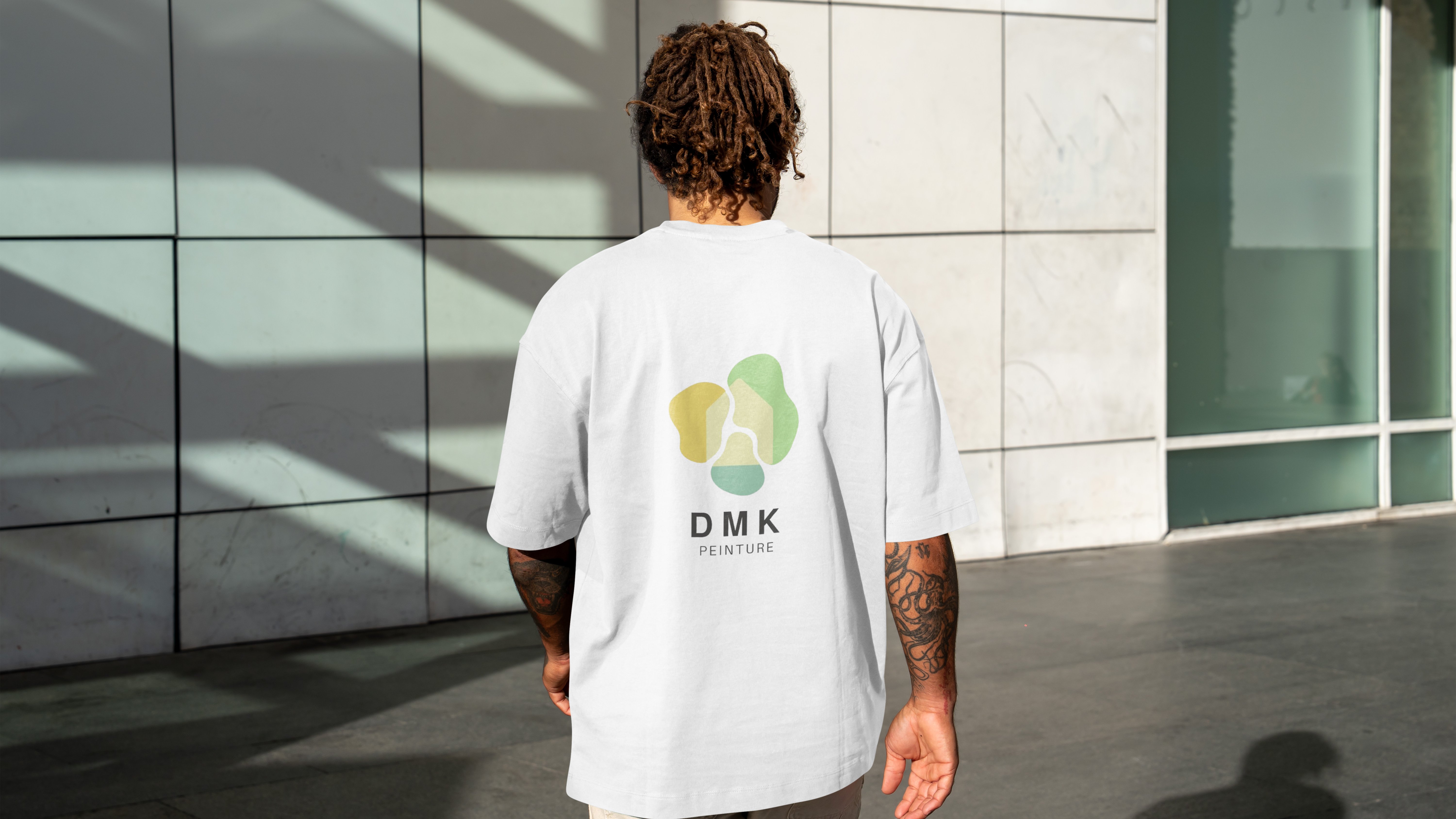 homme de dos avec un t-shirt avec le logo dmk